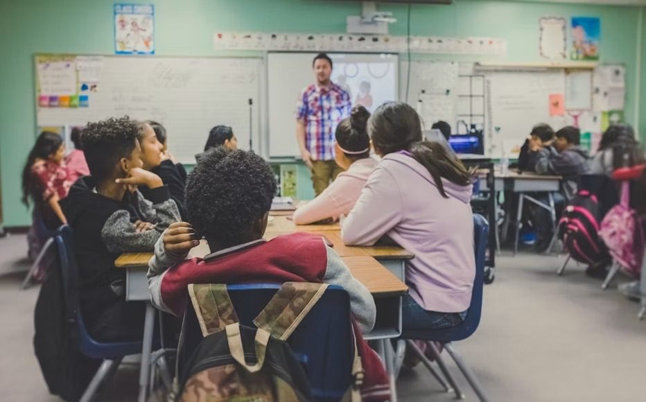 Teacher shortage in Luton: qualified teacher teaching a classroom.